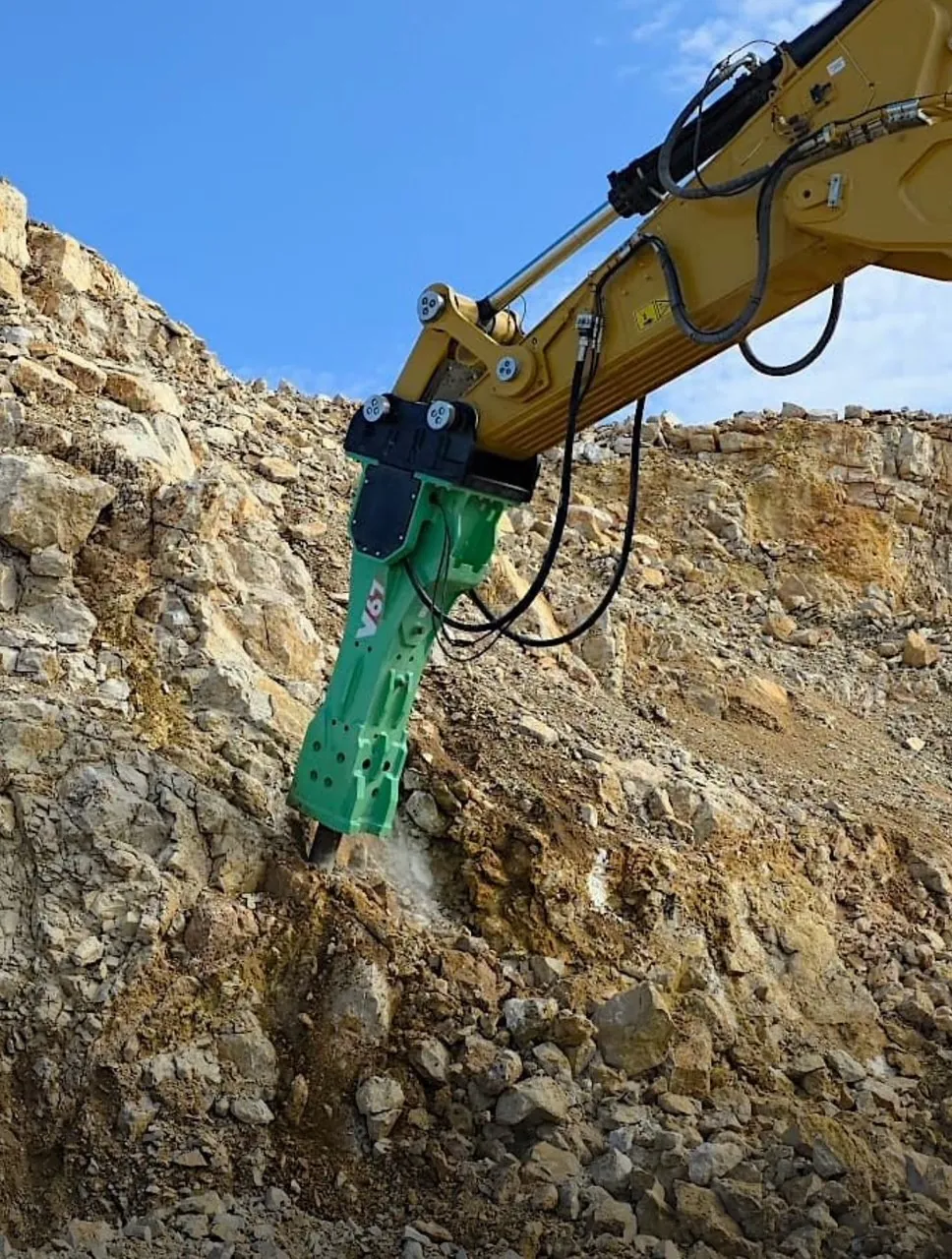 Montabert V65 breaker on a Cat excavator breaking quarry rock