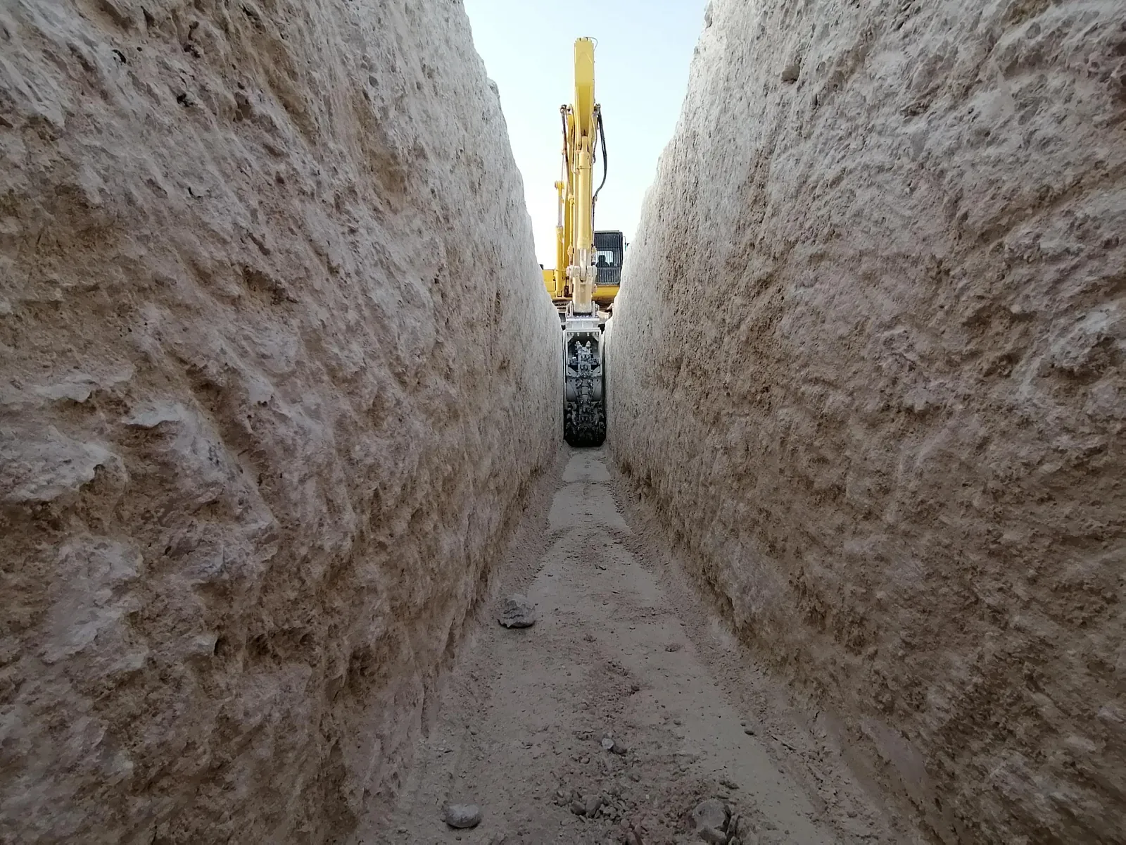 Kemroc KTR chain trencher cutting a narrow trench in limestone