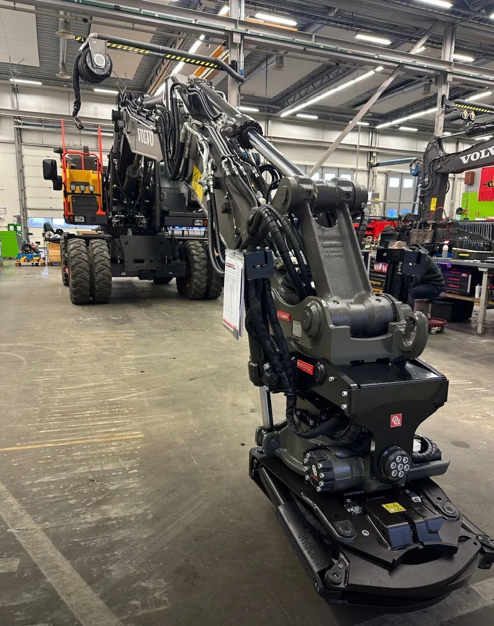 Volvo excavator with OilQuick OQ60 coupler in a workshop
